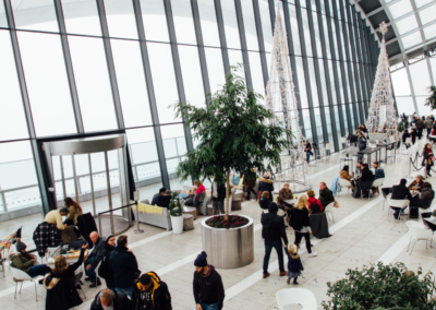 Messehalle mit Tischen und Personen
